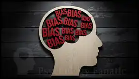 A wooden silhouette of a human head in profile, with the brain area completely filled with the repeated red word "BIAS," illustrating the concept of cognitive bias and attribute substitution.